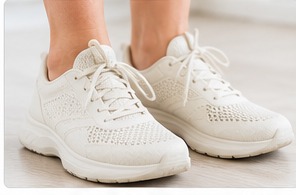 A pair of wide, cushioned white trainers.