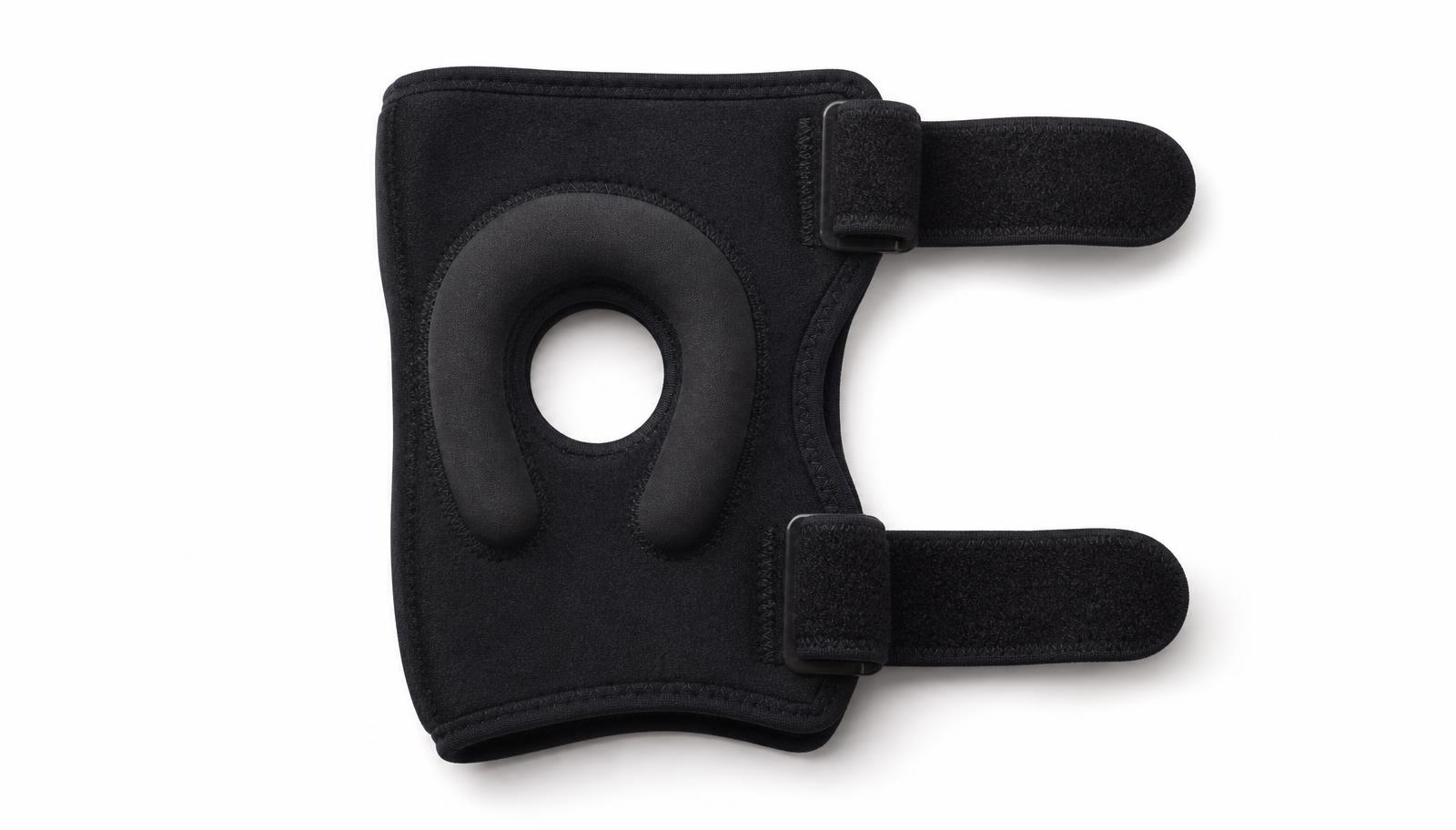 A neoprene patellar stabilising knee brace with a padded horseshoe buttress around the kneecap opening.
