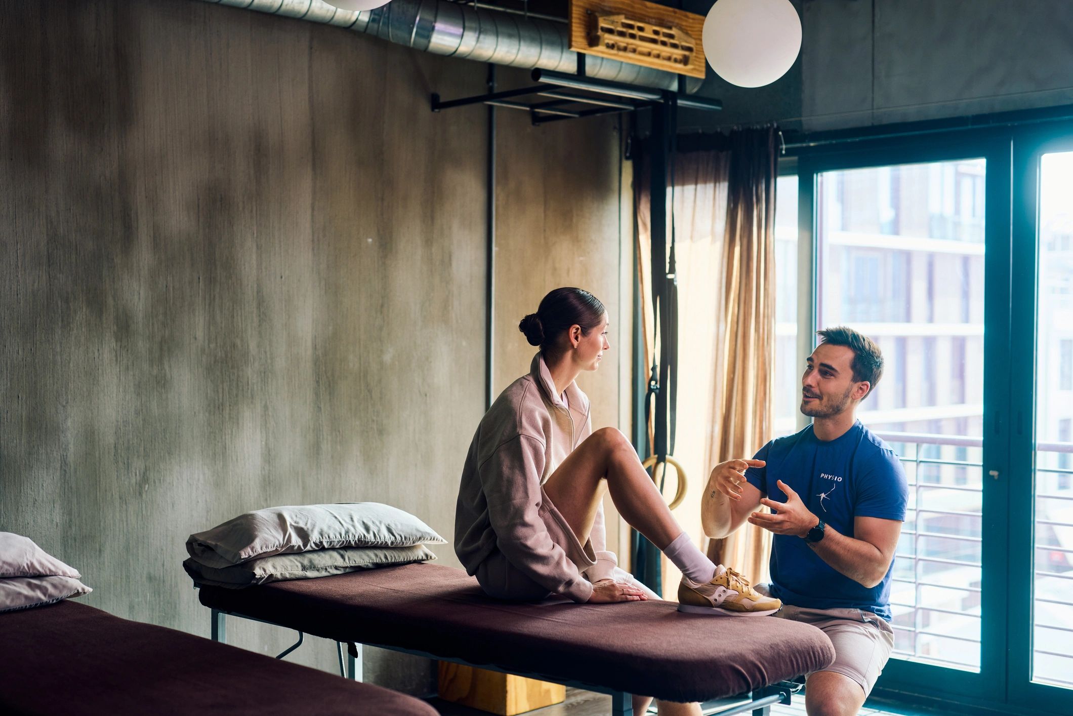 Physiotherapist performing a knee examination on a patient in a rehabilitation clinic